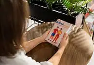 Woman holding Neuro Surge bottle, a natural supplement for memory and focus